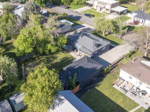 Two-story residence with a dark gray exterior and a shingled roof