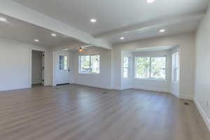 Spacious room with light wood-finish flooring