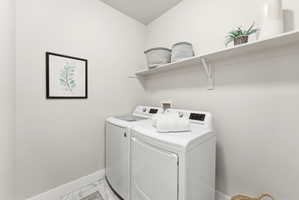 Dedicated laundry room on main floor featuring a full-size washer and dryer