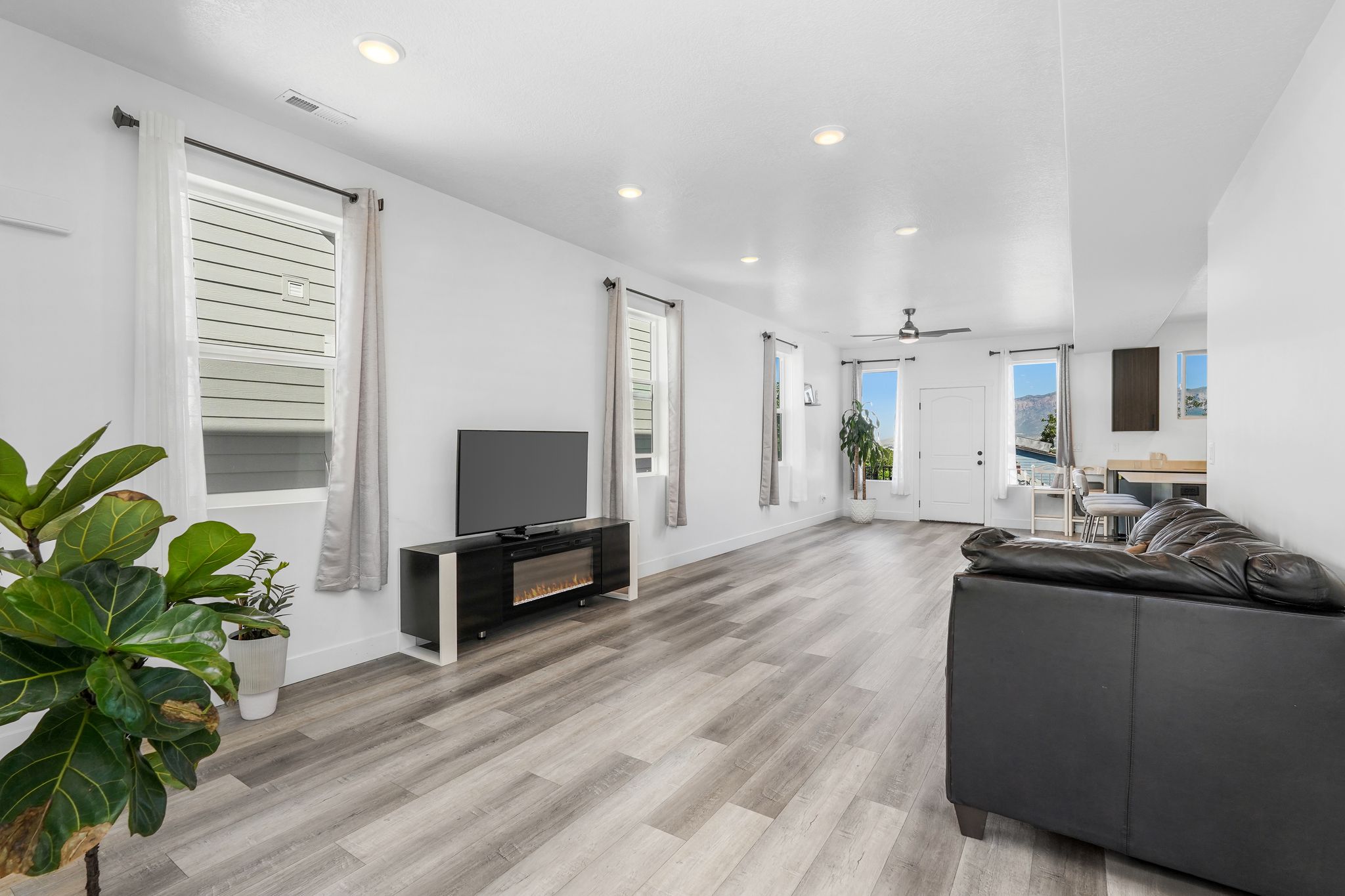 Open-concept living area featuring wood-finish flooring and recessed lighting