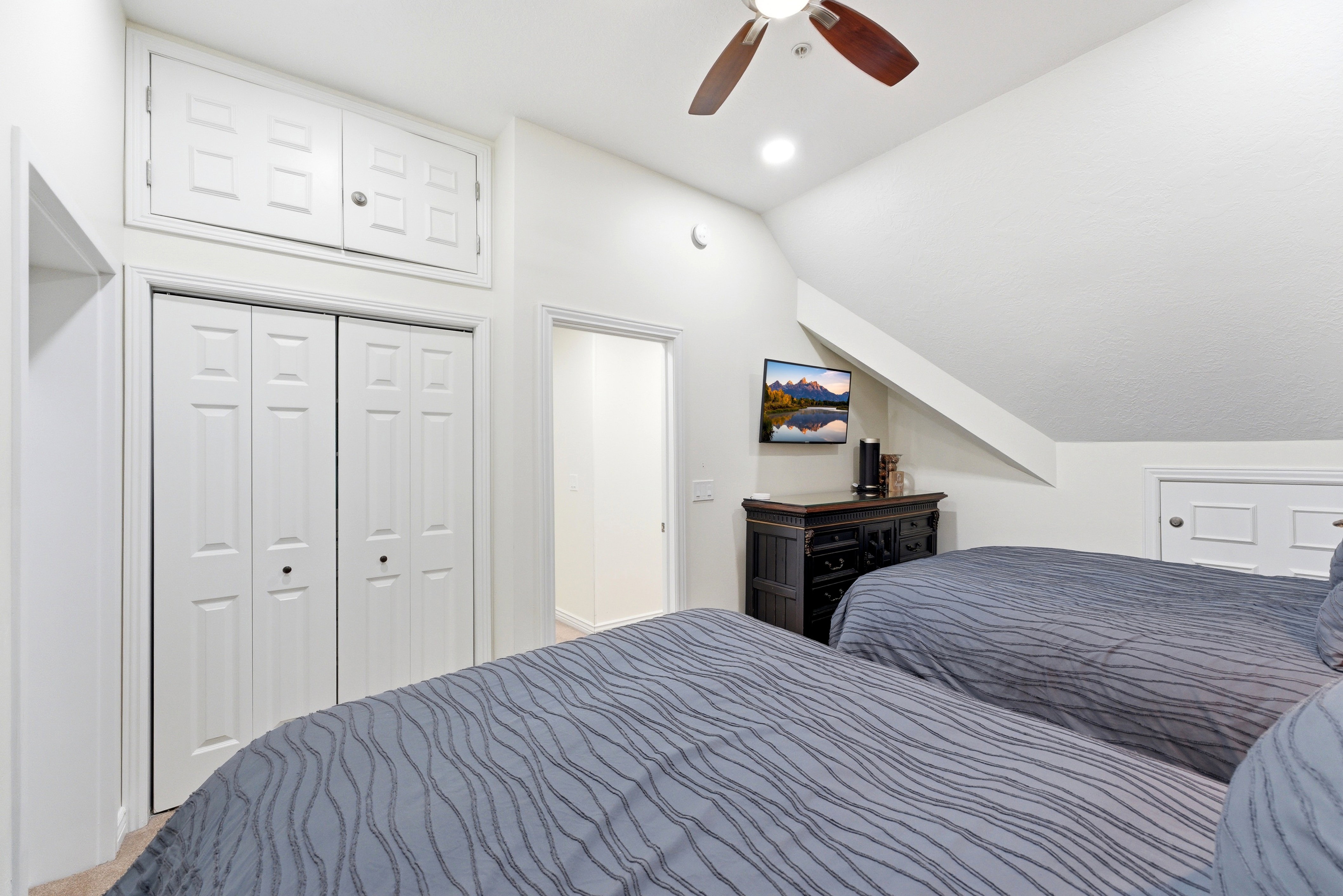 Bedroom with lofted ceiling, a ceiling fan, a closet, and recessed lighting