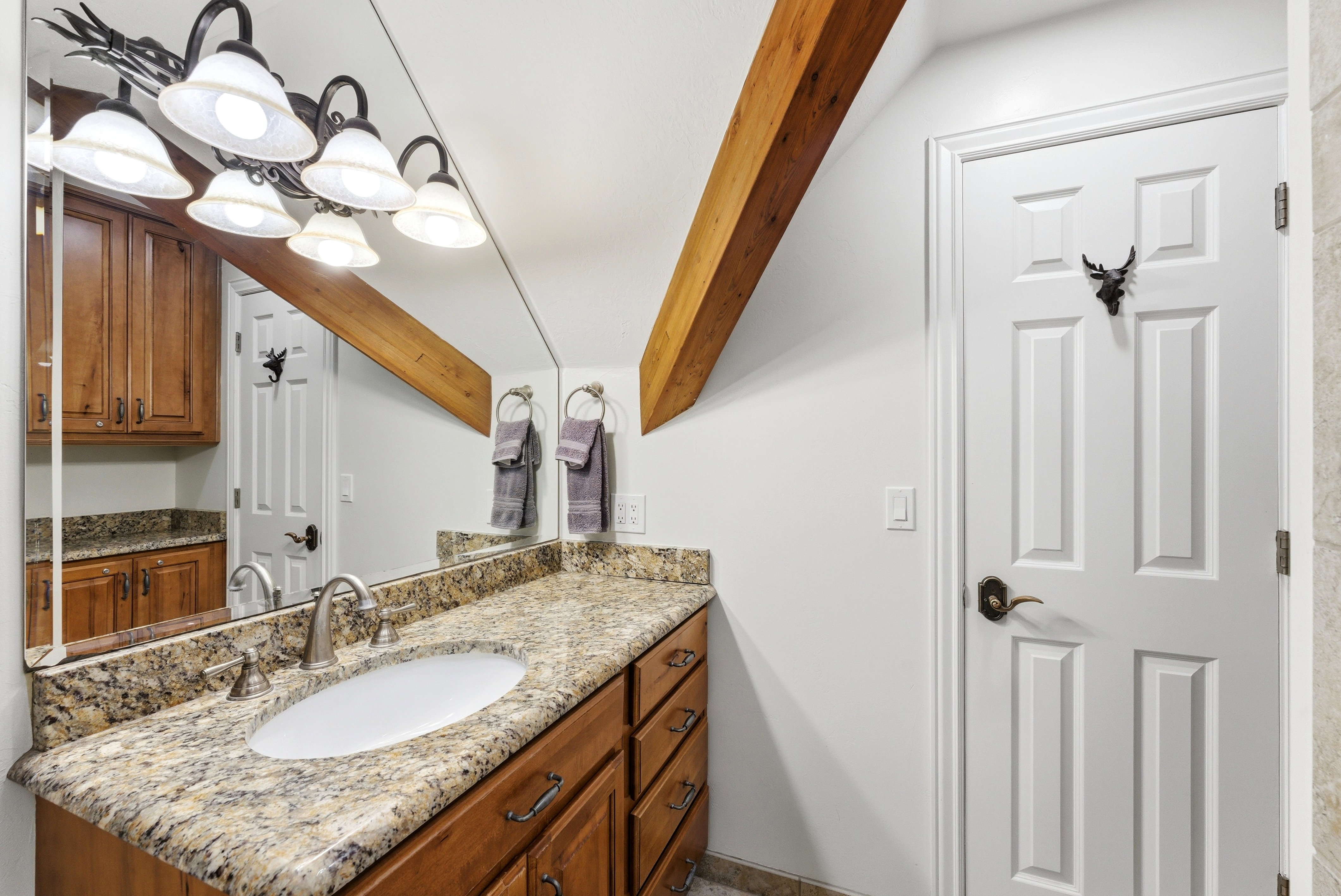 Bathroom featuring vanity and beamed ceiling