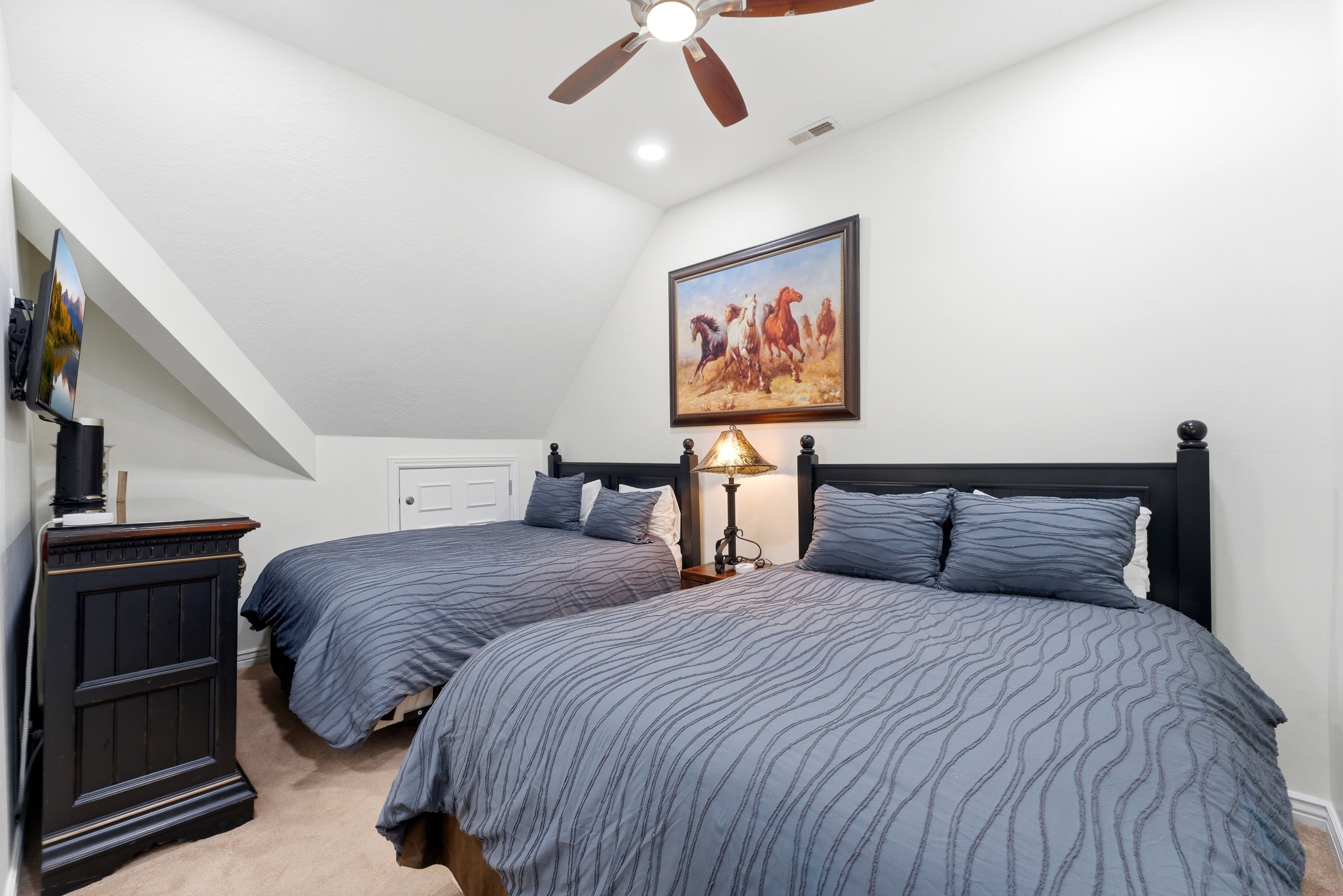 Bedroom featuring vaulted ceiling, light colored carpet, and a ceiling fan