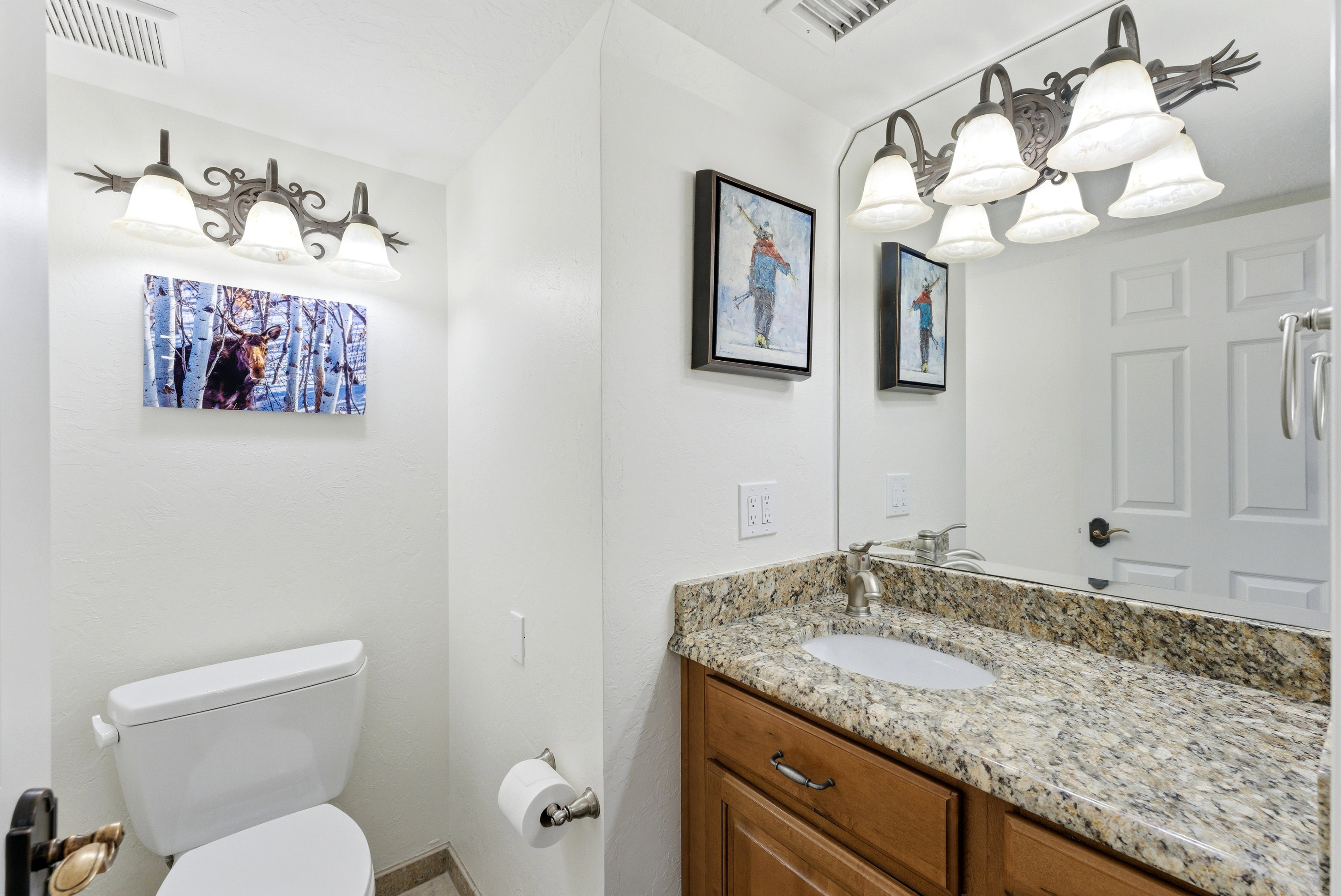 Half bathroom with toilet and vanity