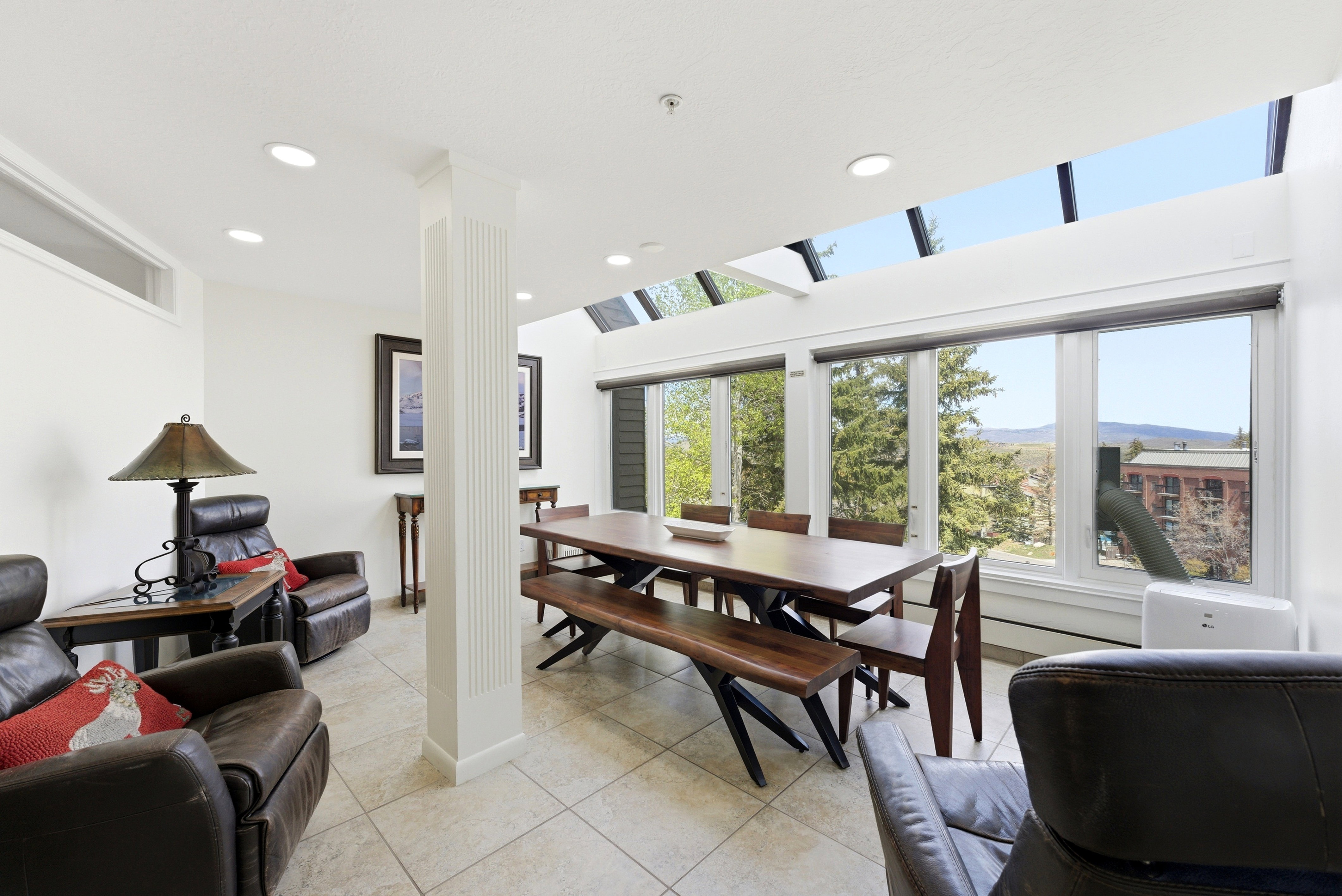 Dining room featuring light tile patterned flooring, recessed lighting, and a mountain view