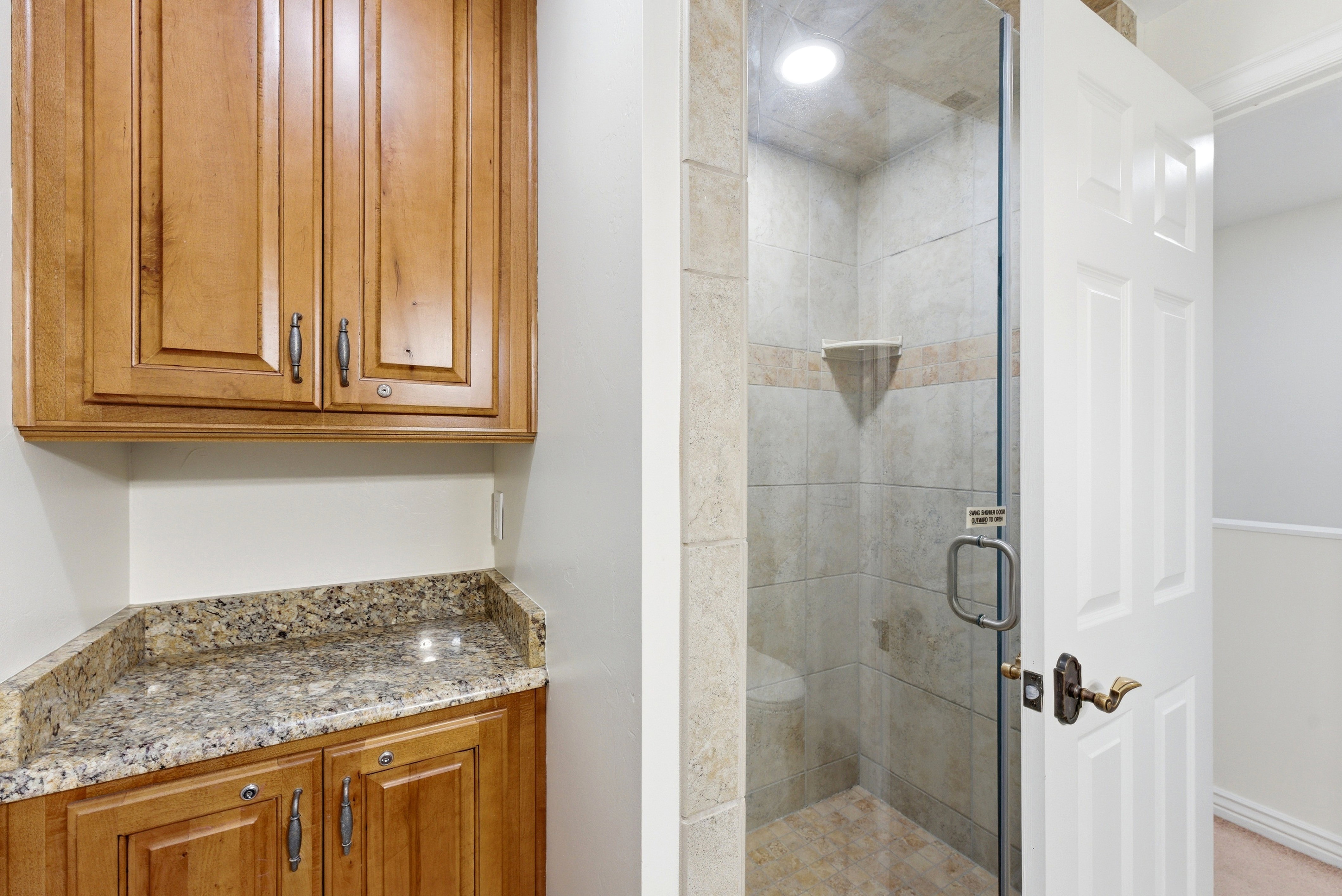 Bathroom featuring a stall shower and vanity