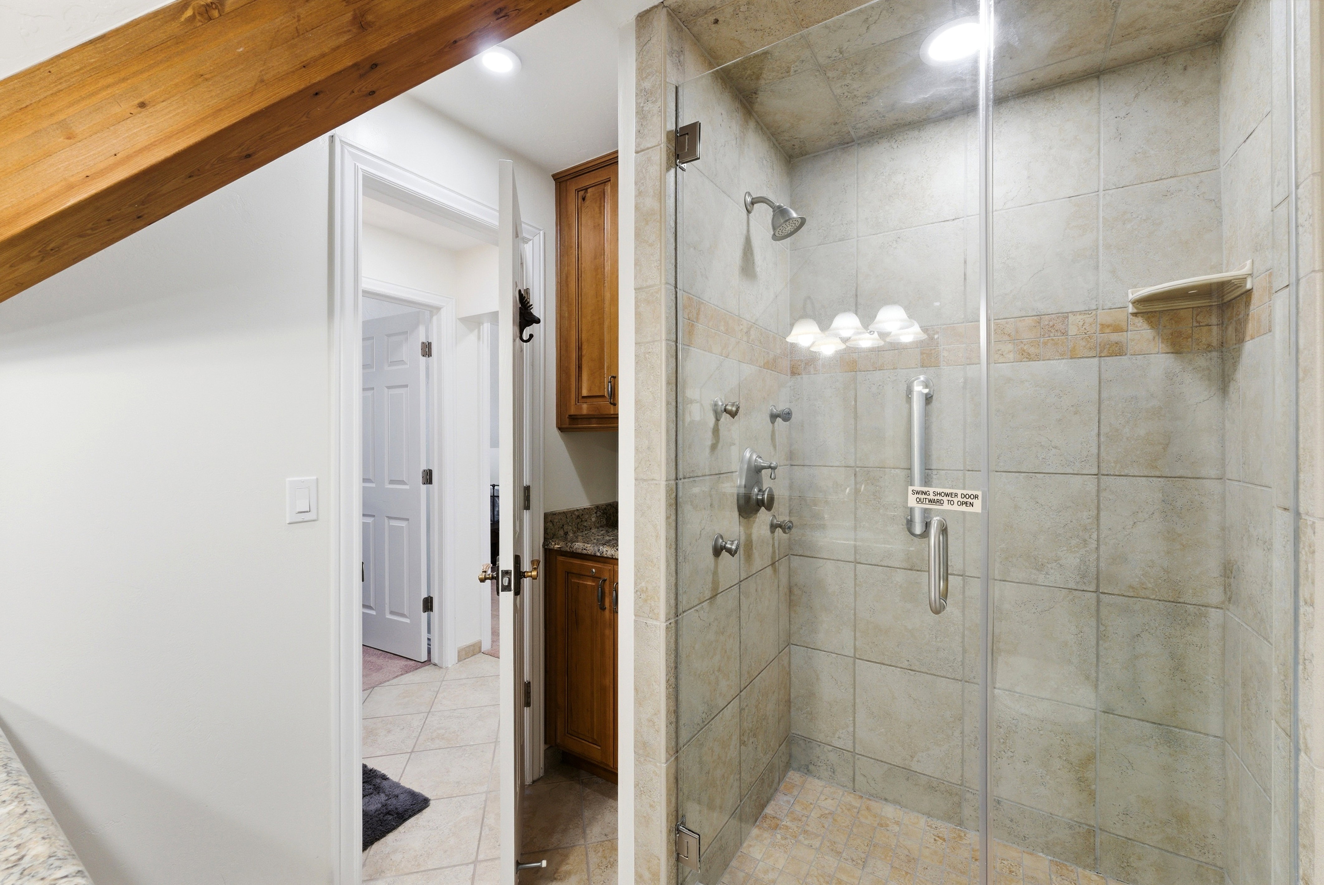 Bathroom featuring a stall shower, light tile patterned floors, recessed lighting, and vanity