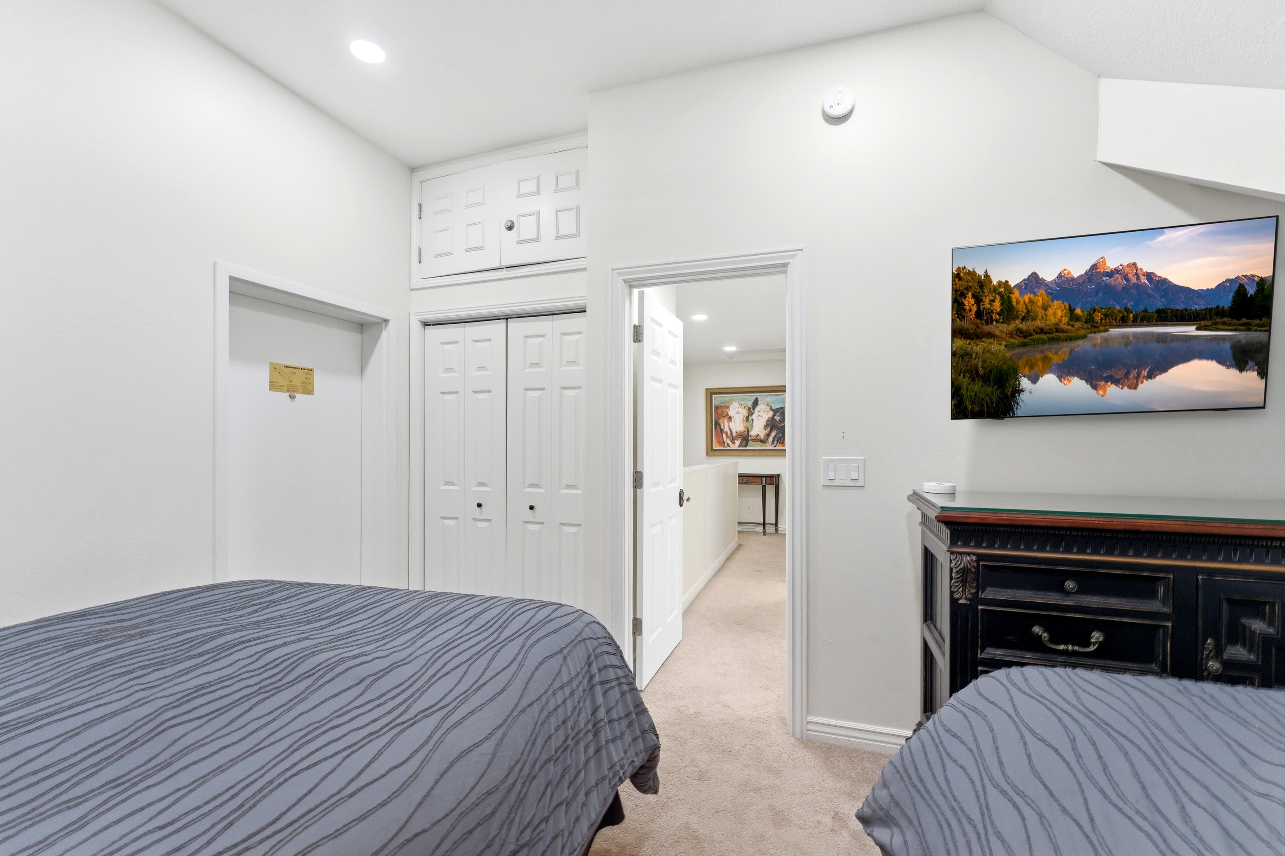 Bedroom with light carpet, a closet, and recessed lighting