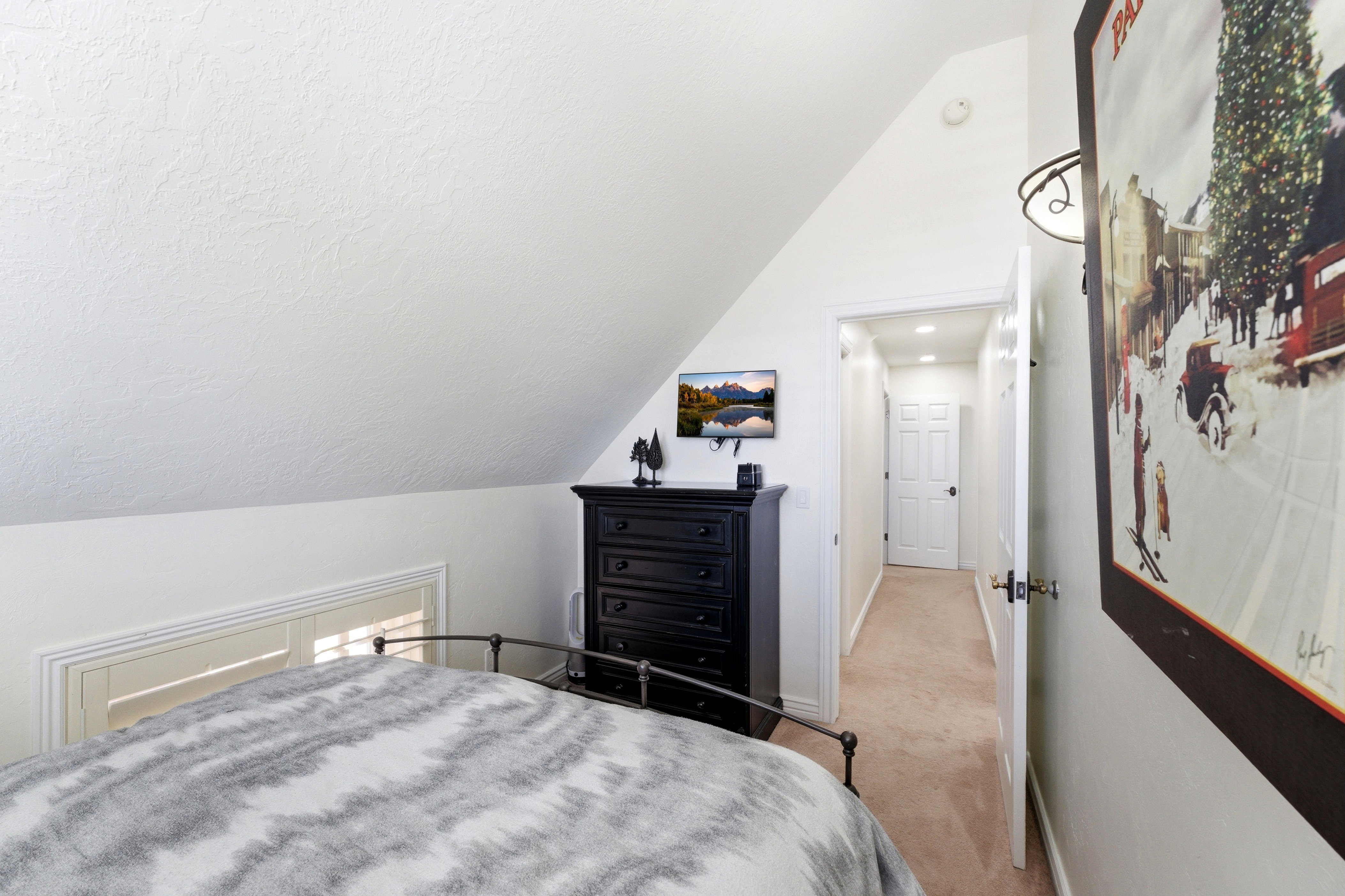 Bedroom with lofted ceiling and light carpet