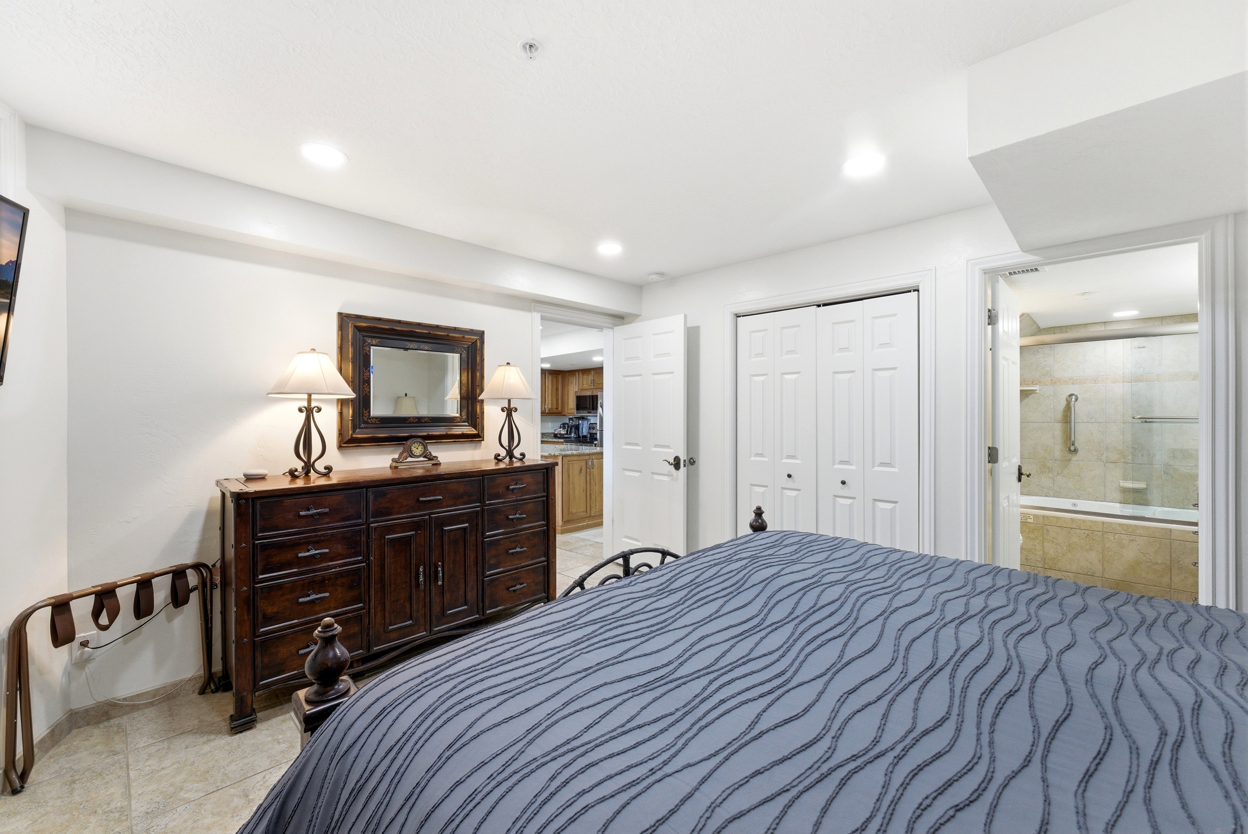Bedroom with a closet, ensuite bathroom, recessed lighting, and light tile patterned flooring