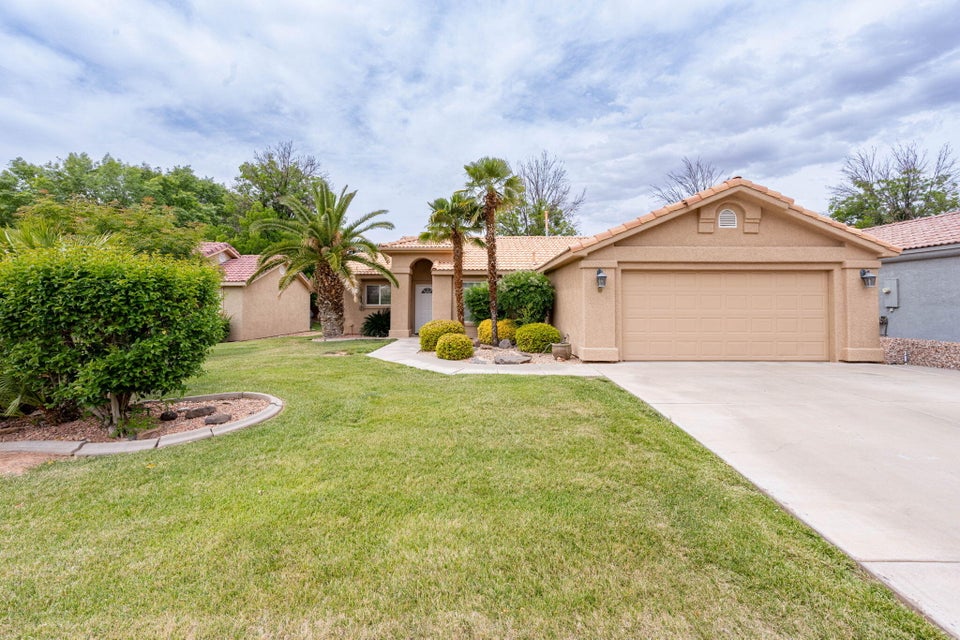Single-story residence featuring a stucco exterior and a tile roof
