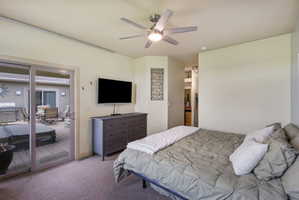 Room featuring a ceiling fan with integrated lighting and sliding glass door access to an exterior deck
