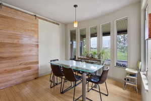 Interior space featuring light wood-finish flooring and a wood barn door
