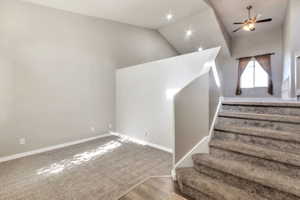 Carpeted staircase with white balustrade leading to an upper level