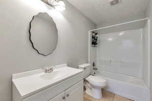 Bathroom featuring a white vanity with integrated sink, chrome faucet, and a contemporary wall-mounted mirror