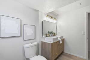 Dual rectangular vessel sinks with gold-finish faucets and a wood-finish vanity with gold hardware