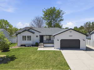 White exterior with dark trim and a dark gray garage door
