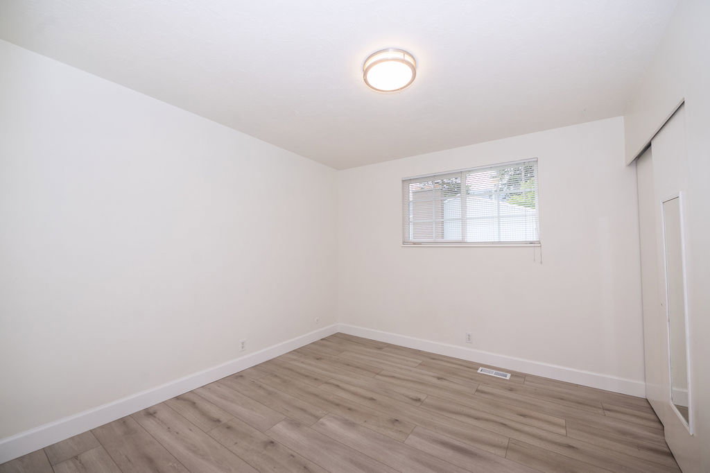 Interior room featuring light wood-finish flooring, white walls, and white trim