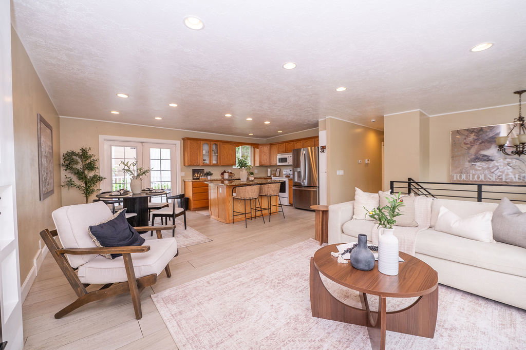 Open-concept living area featuring light wood-finish flooring, recessed lighting, and neutral wall tones