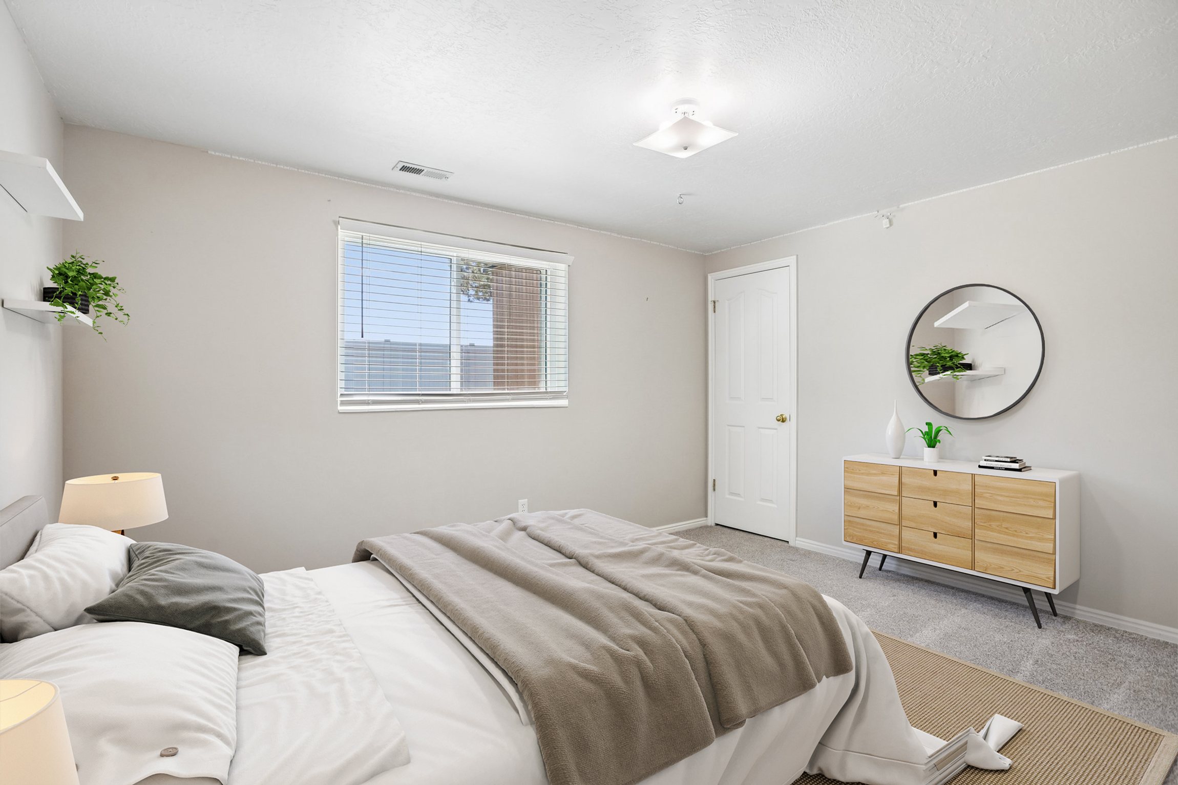 Carpeted bedroom featuring a single window with blinds, a white paneled door, and a flush mount ceiling light