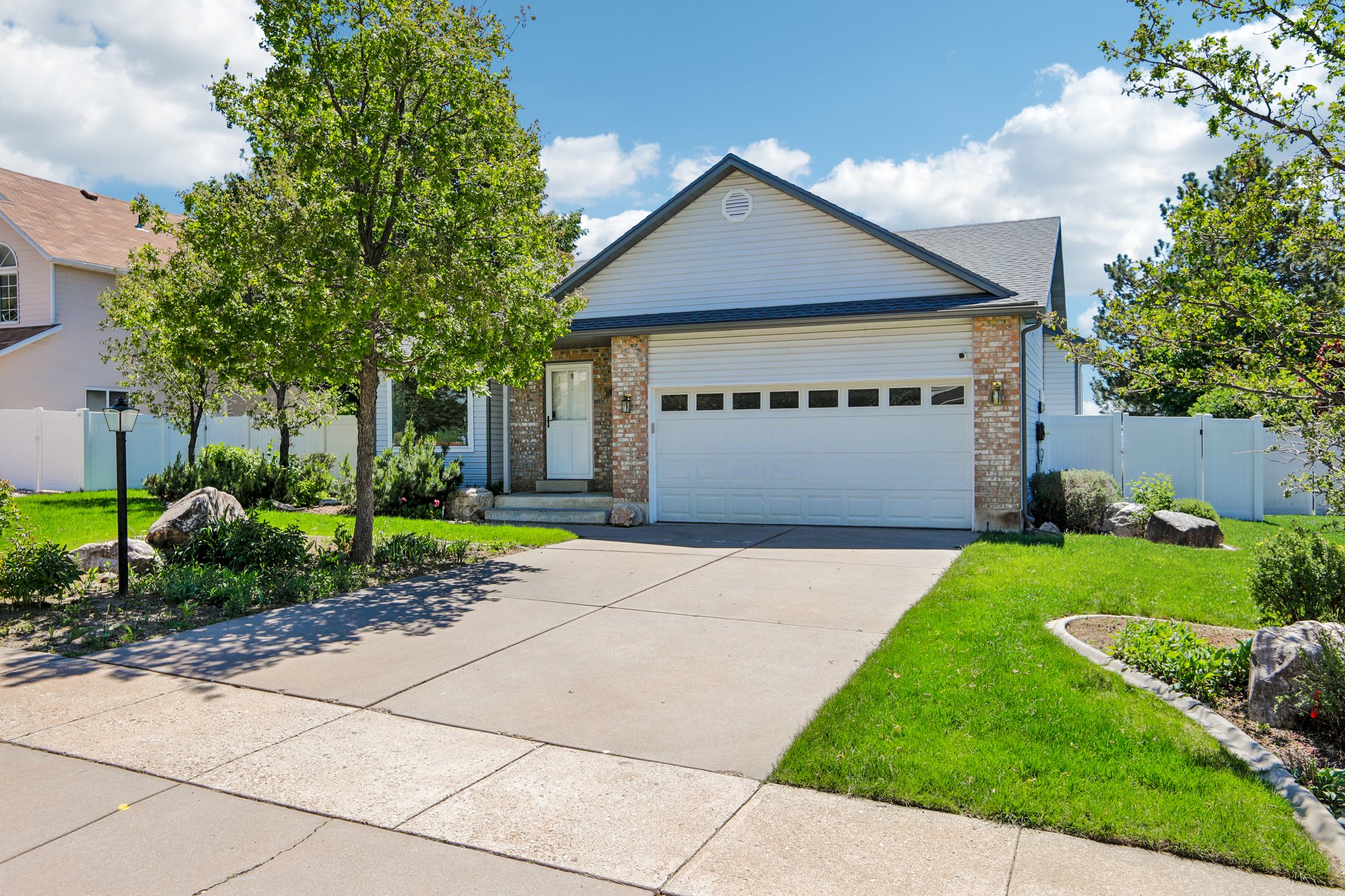 Exterior featuring light-colored siding and brick accents