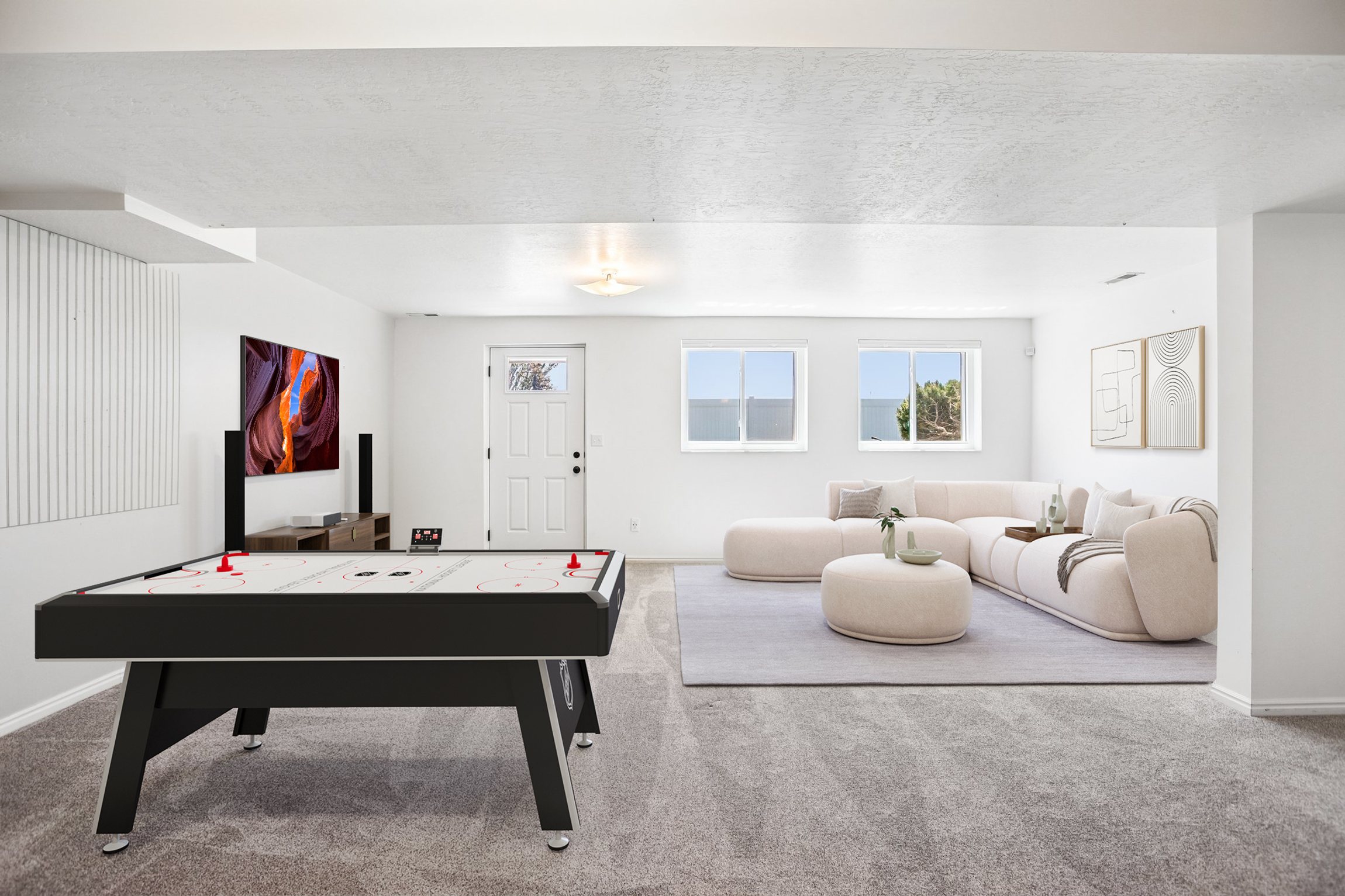 Spacious room featuring light-colored walls, recessed lighting, and carpet flooring