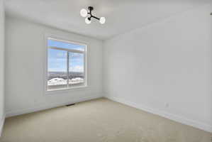 Bright room featuring a large window, neutral wall paint, and a modern ceiling light fixture