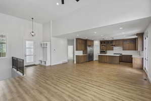 Expansive open-concept living area featuring wood-finish flooring and soaring ceilings