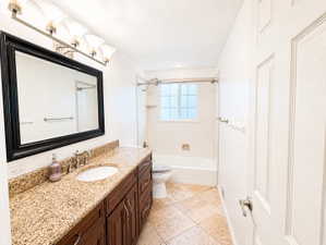 Bathroom with vanity, shower / bathtub combination, and light tile patterned flooring