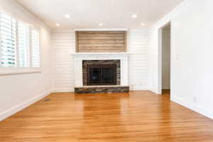 Unfurnished living room featuring recessed lighting, wood finished floors, a fireplace