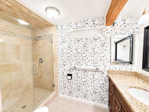 Bathroom featuring vanity and a stall shower