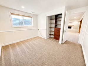 Unfurnished bedroom with light colored carpet, a closet