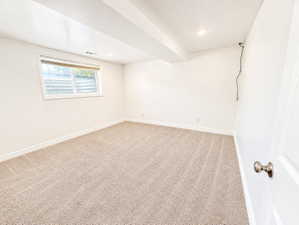 Spare room featuring light colored carpet and recessed lighting