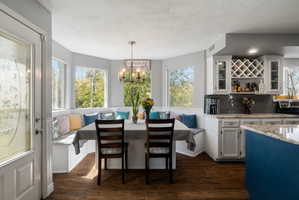Breakfast nook with built-in bench seating and surrounding windows
