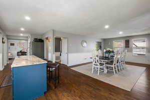Open concept living space featuring wood-finish flooring throughout