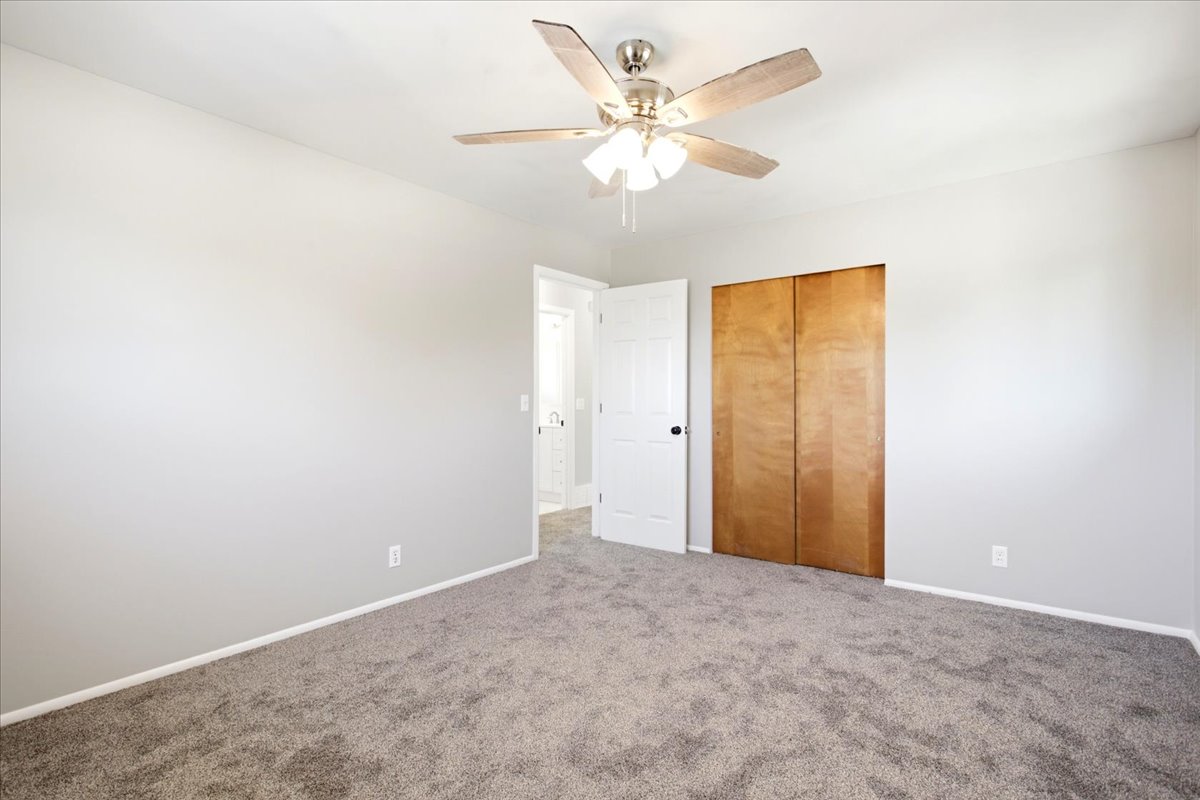 Spacious room with gray carpeting and light gray walls