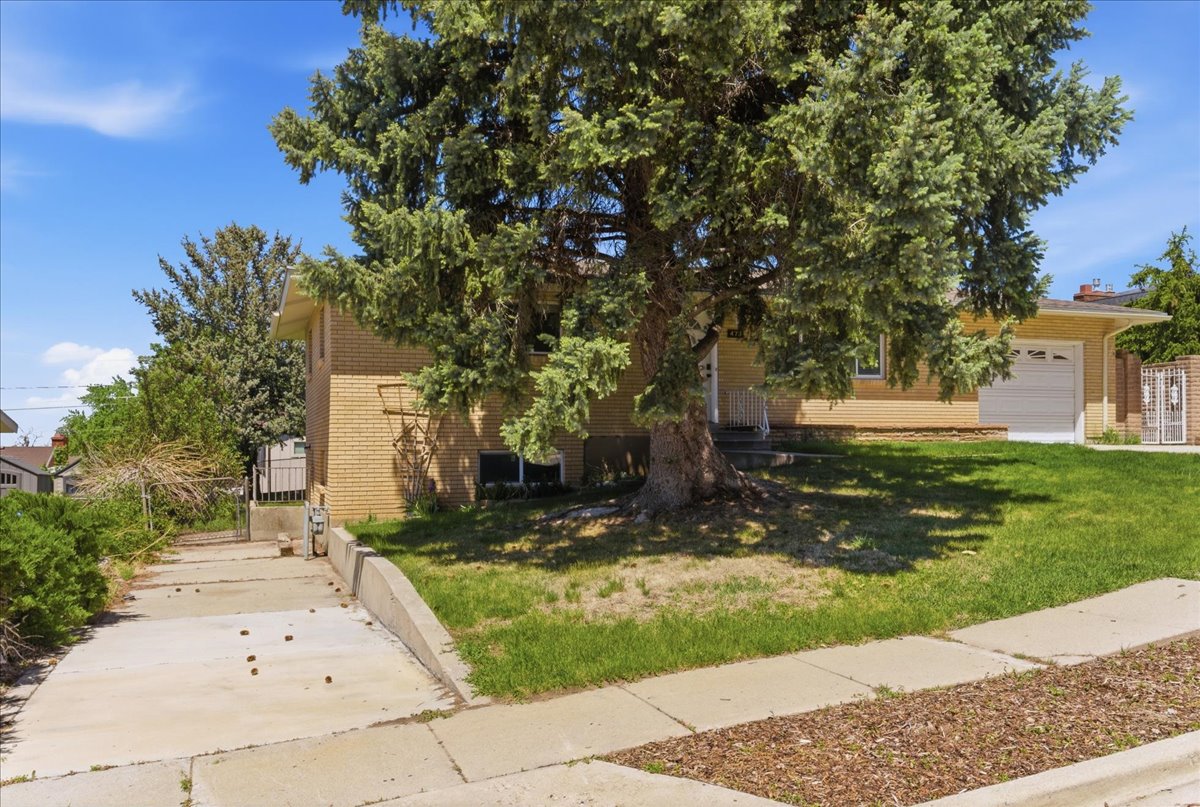 Brick exterior residence featuring an attached garage and a concrete driveway