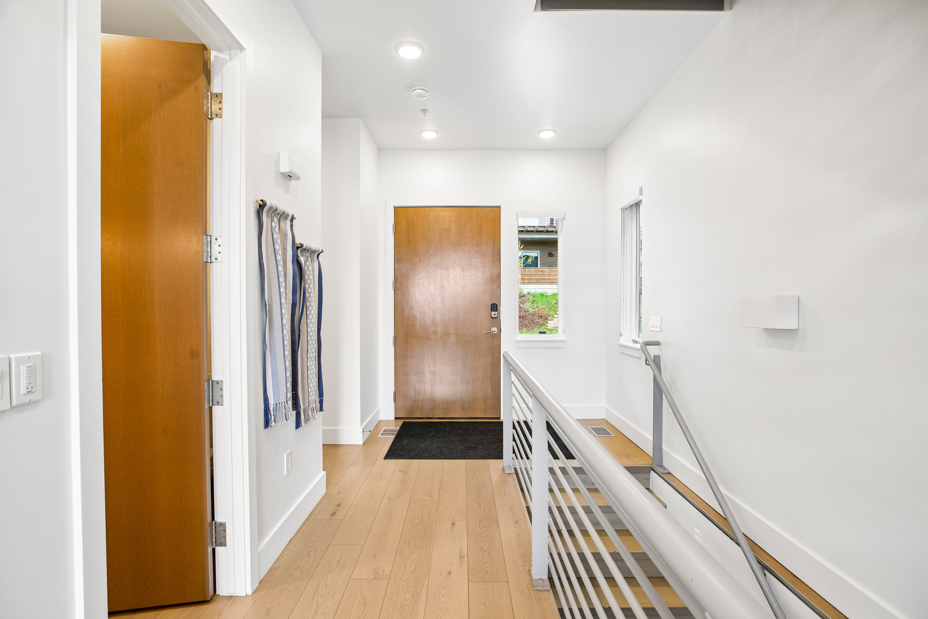 Light wood-finish flooring throughout the entryway