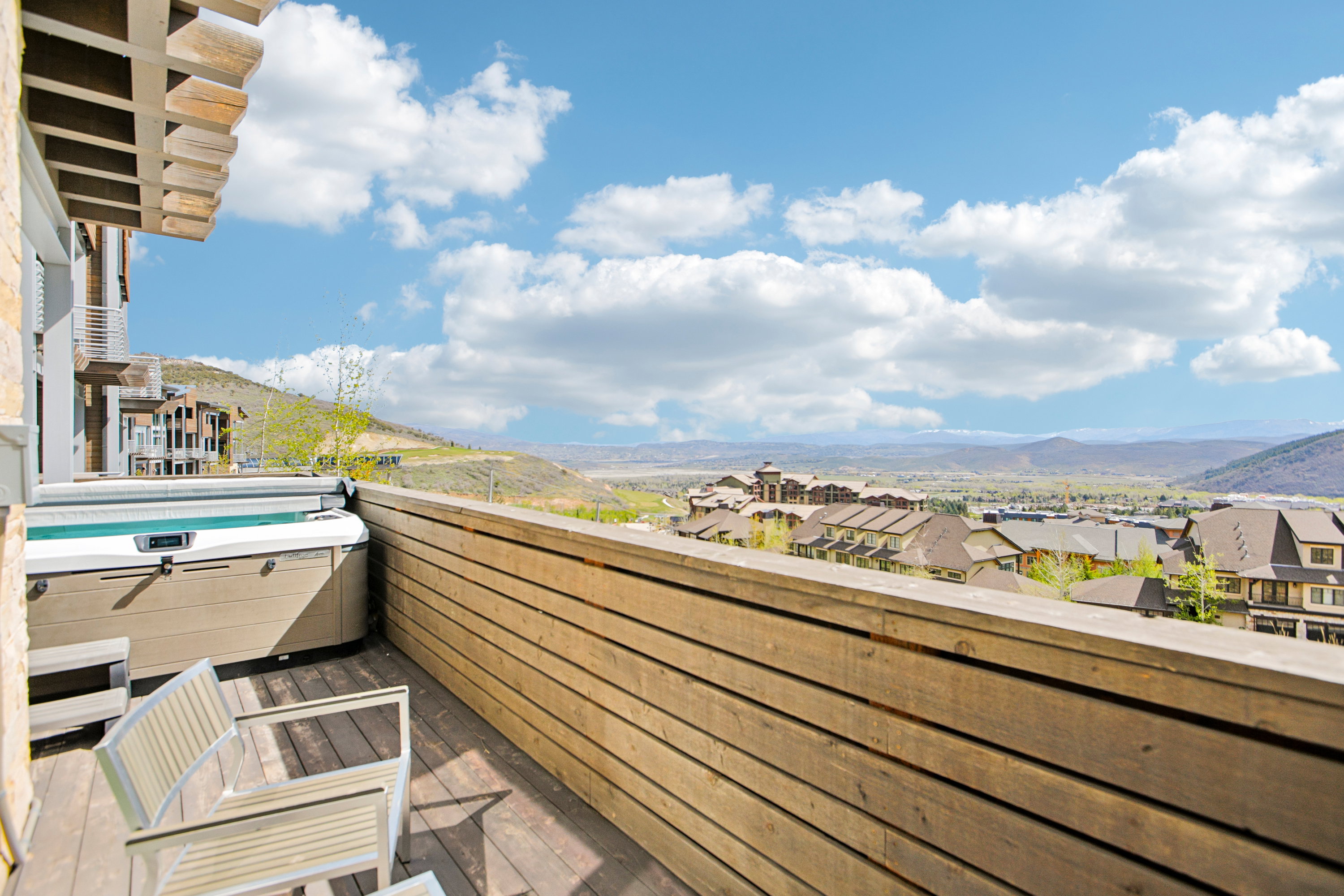 Private outdoor deck featuring a built-in hot tub