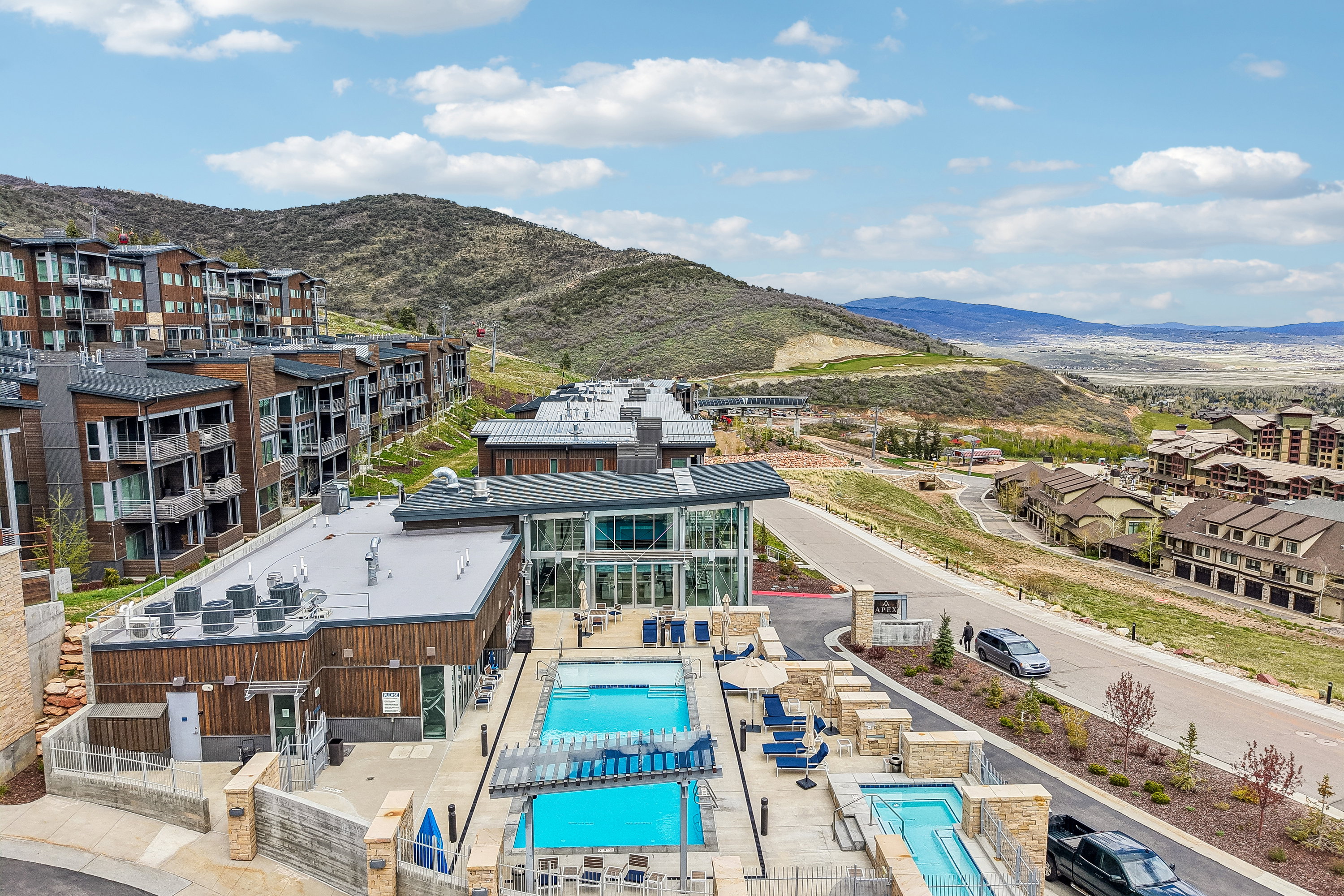 Modern mountain community featuring multiple buildings with wood-finish siding and flat roofs
