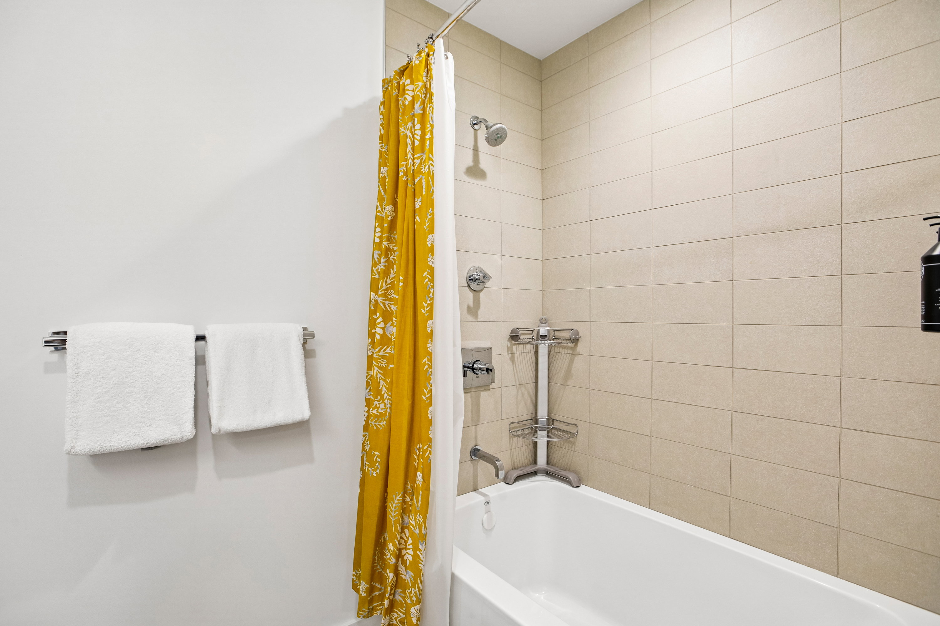 White bathtub with subway-style tiled surround