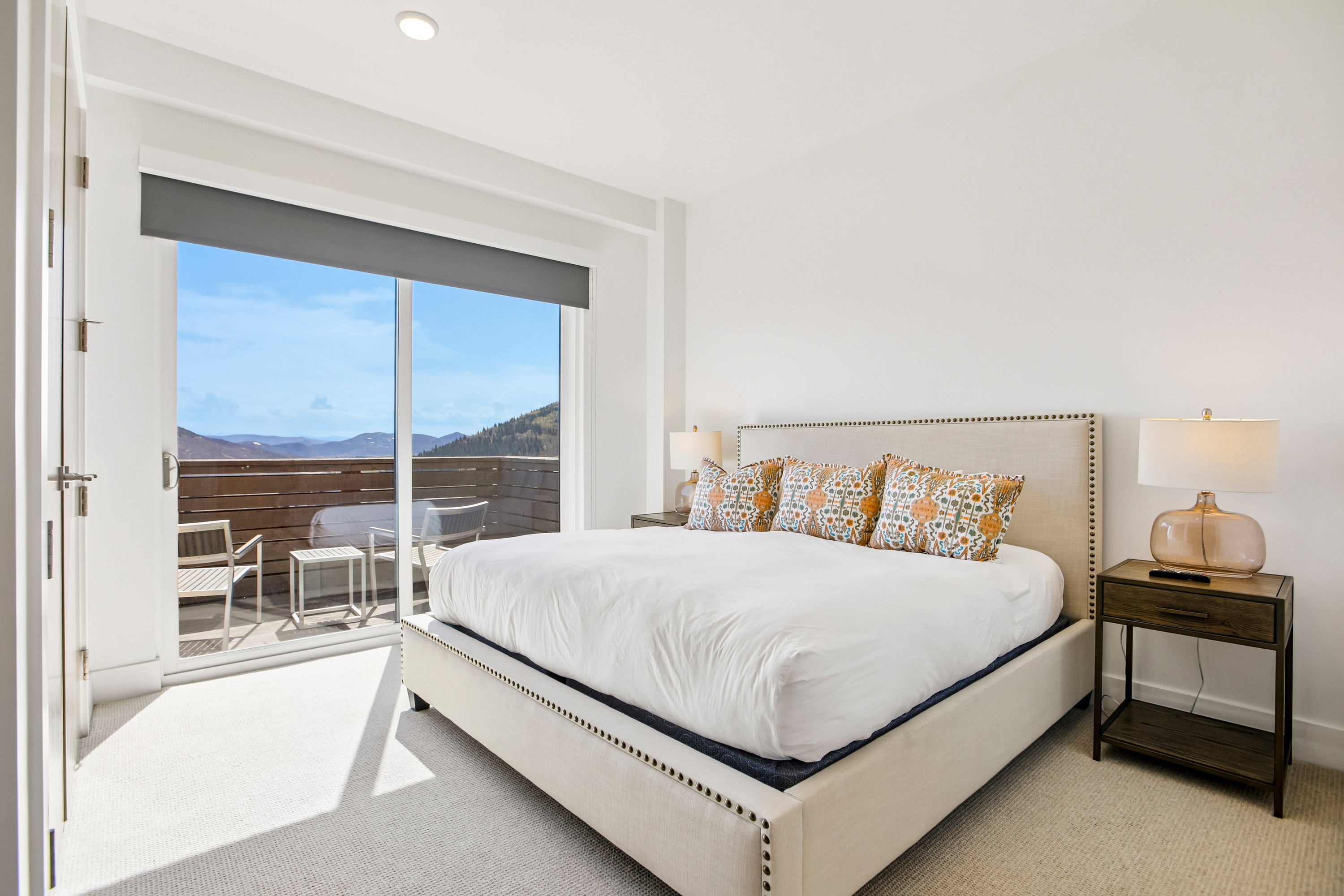 Bedroom with broad sliding glass doors opening to an outdoor patio
