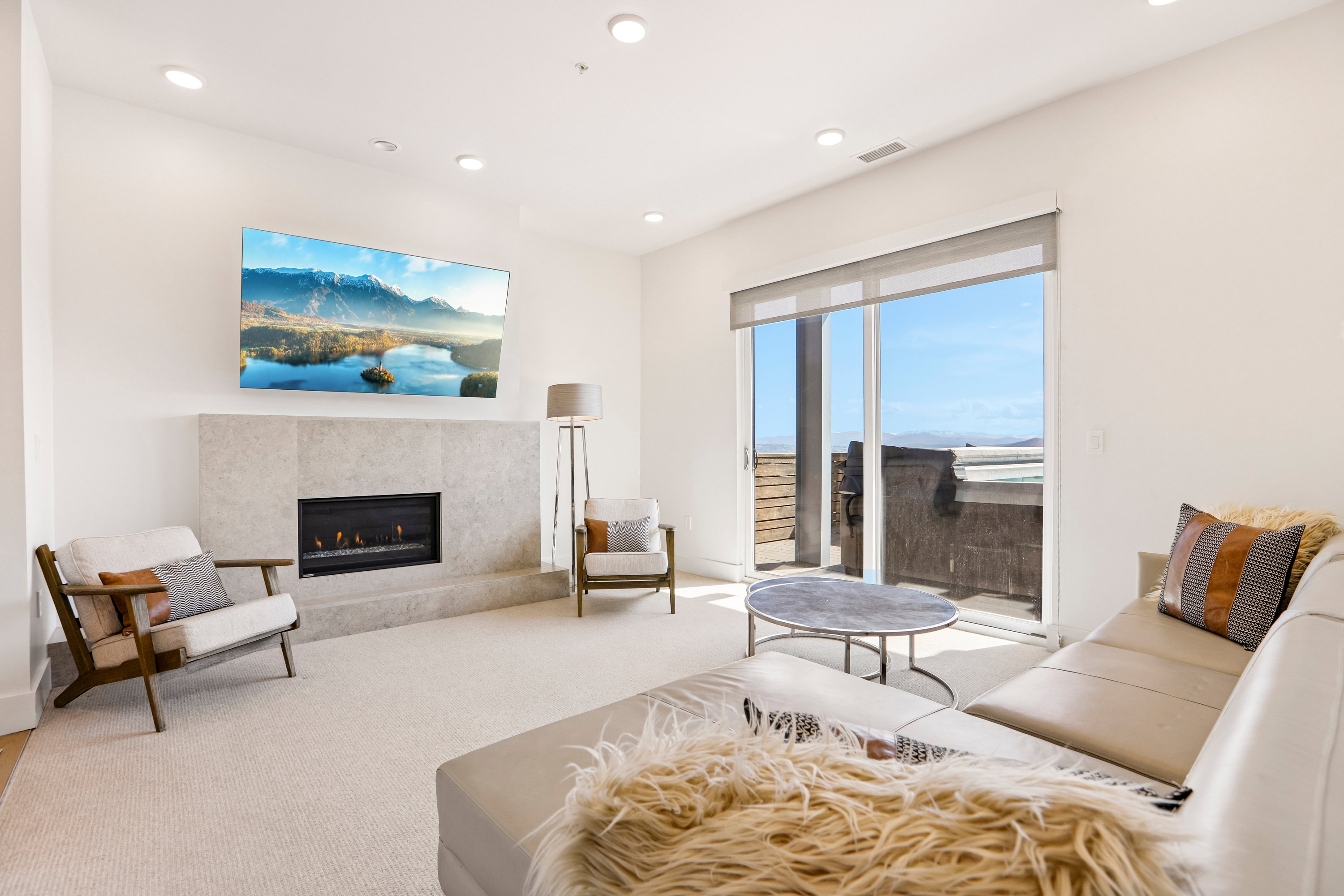Living area featuring a floor-to-ceiling fireplace with a stone surround, a gas insert, and recessed lighting