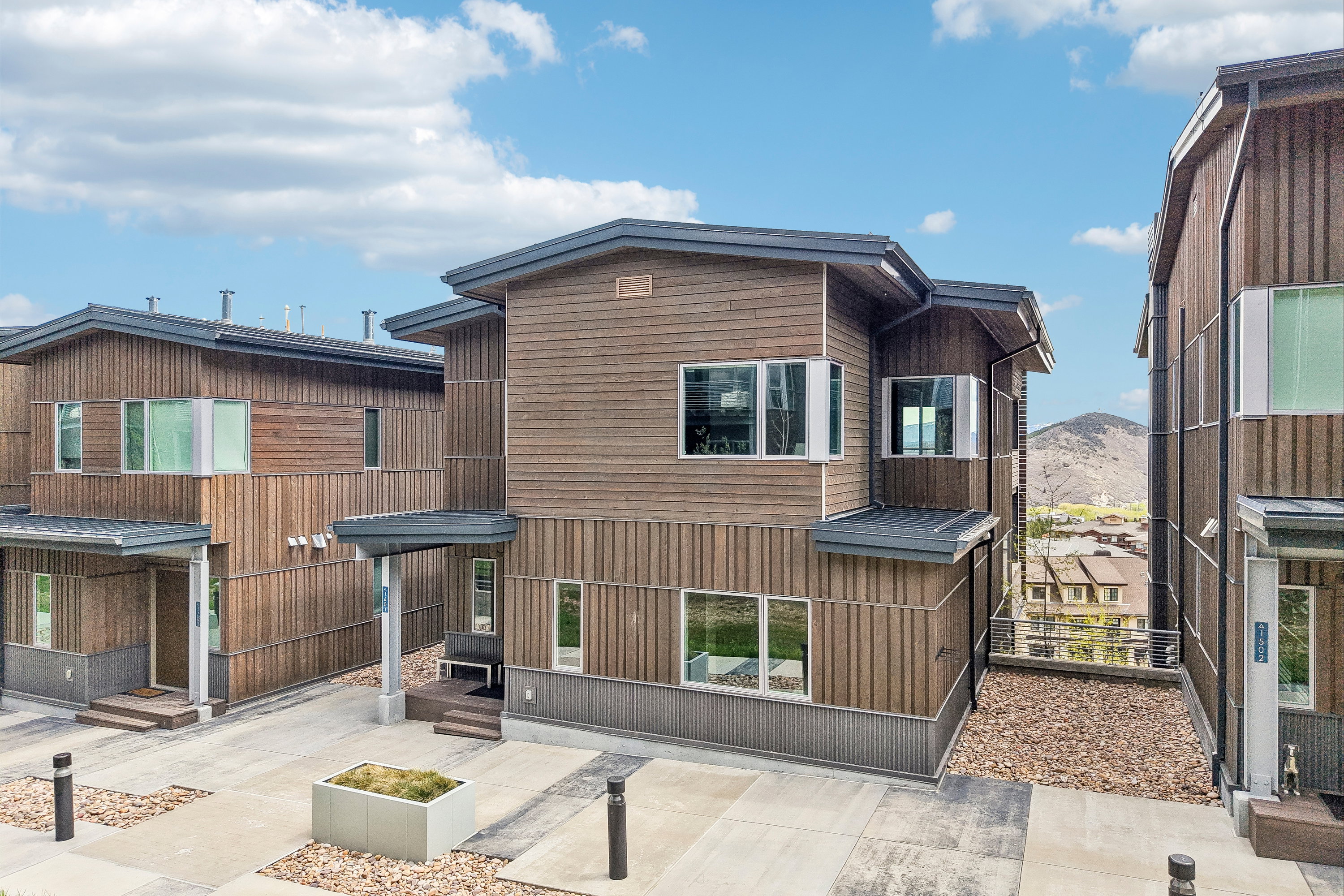 Modern architectural design featuring varied wood paneling and dark trim
