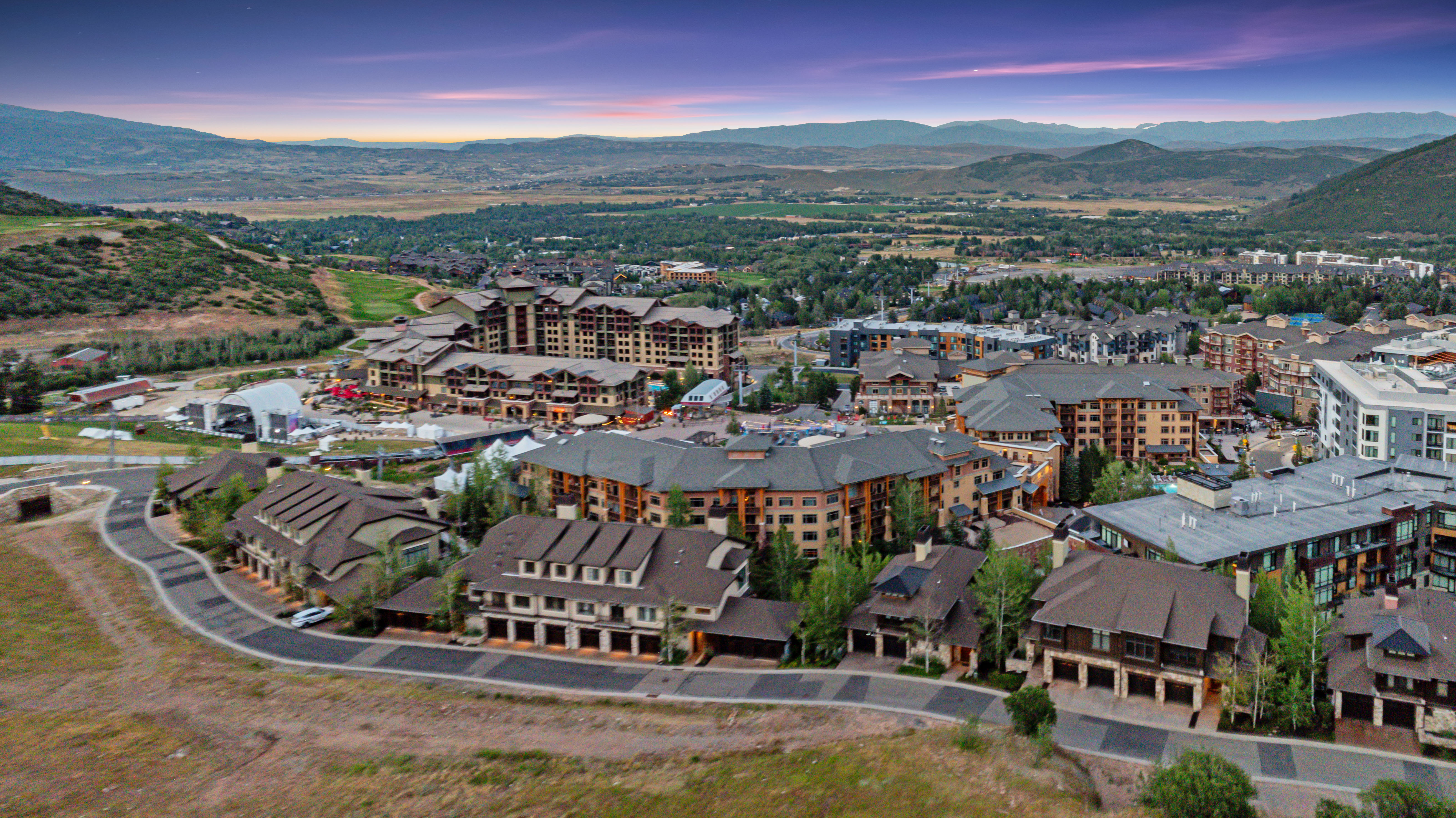 Extensive community featuring multi-story buildings with varied architectural styles, including stone and wood-clad facades, and dark shingled roofs