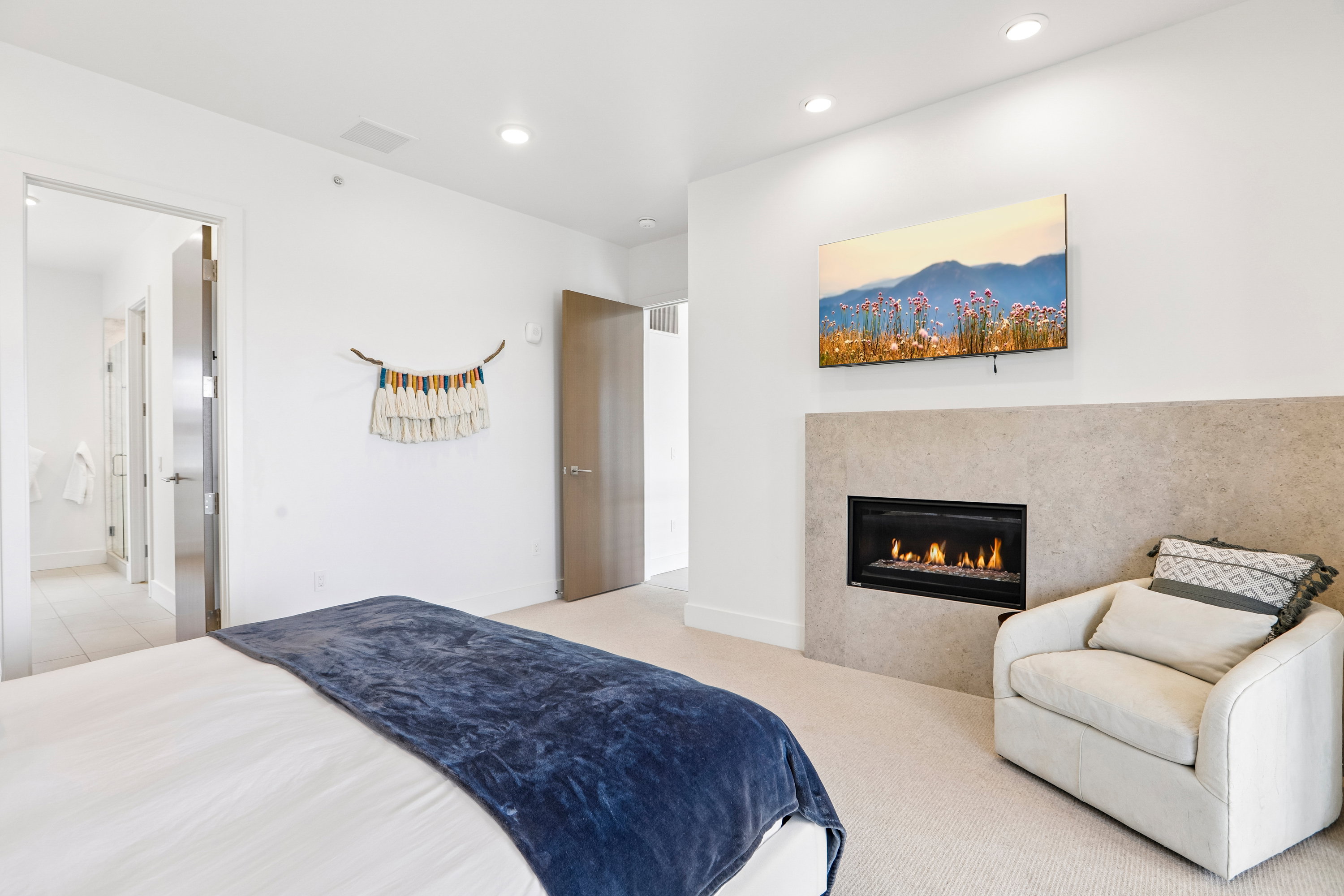 Recessed fireplace with a stone surround, integrated into a white wall