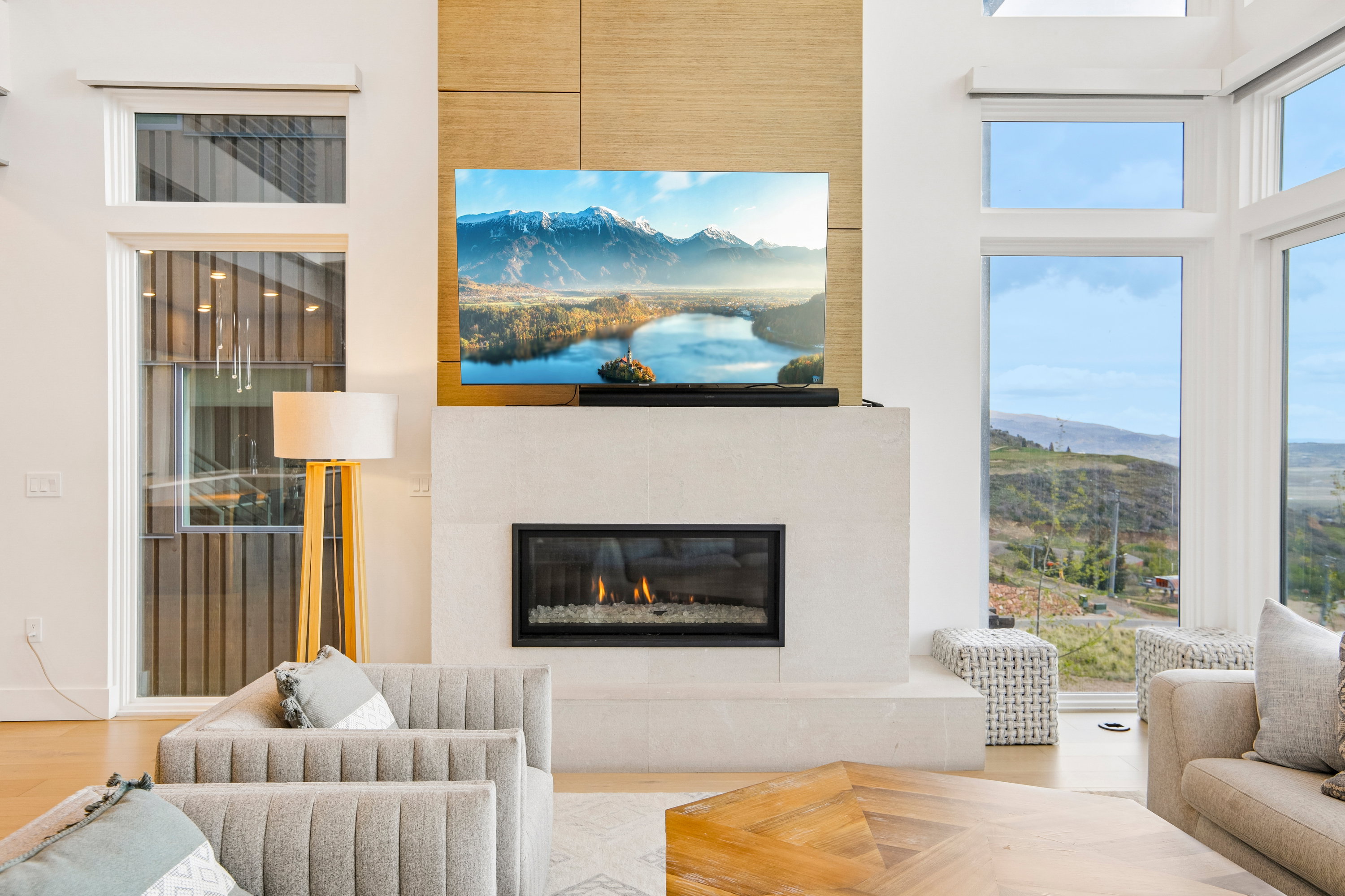 Integrated fireplace with a stone surround and a decorative wood-finish accent wall