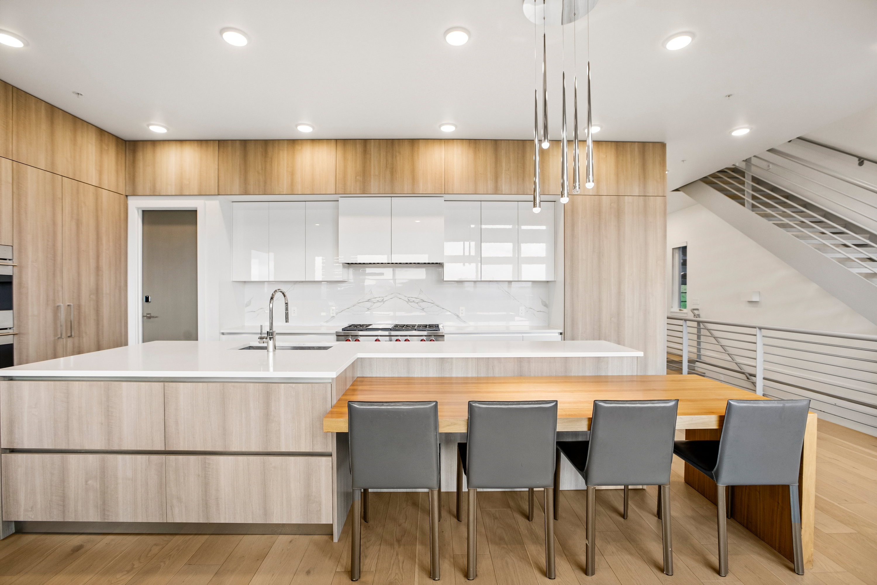 Kitchen featuring wood-finish cabinetry, white countertops, and a white tile backsplash