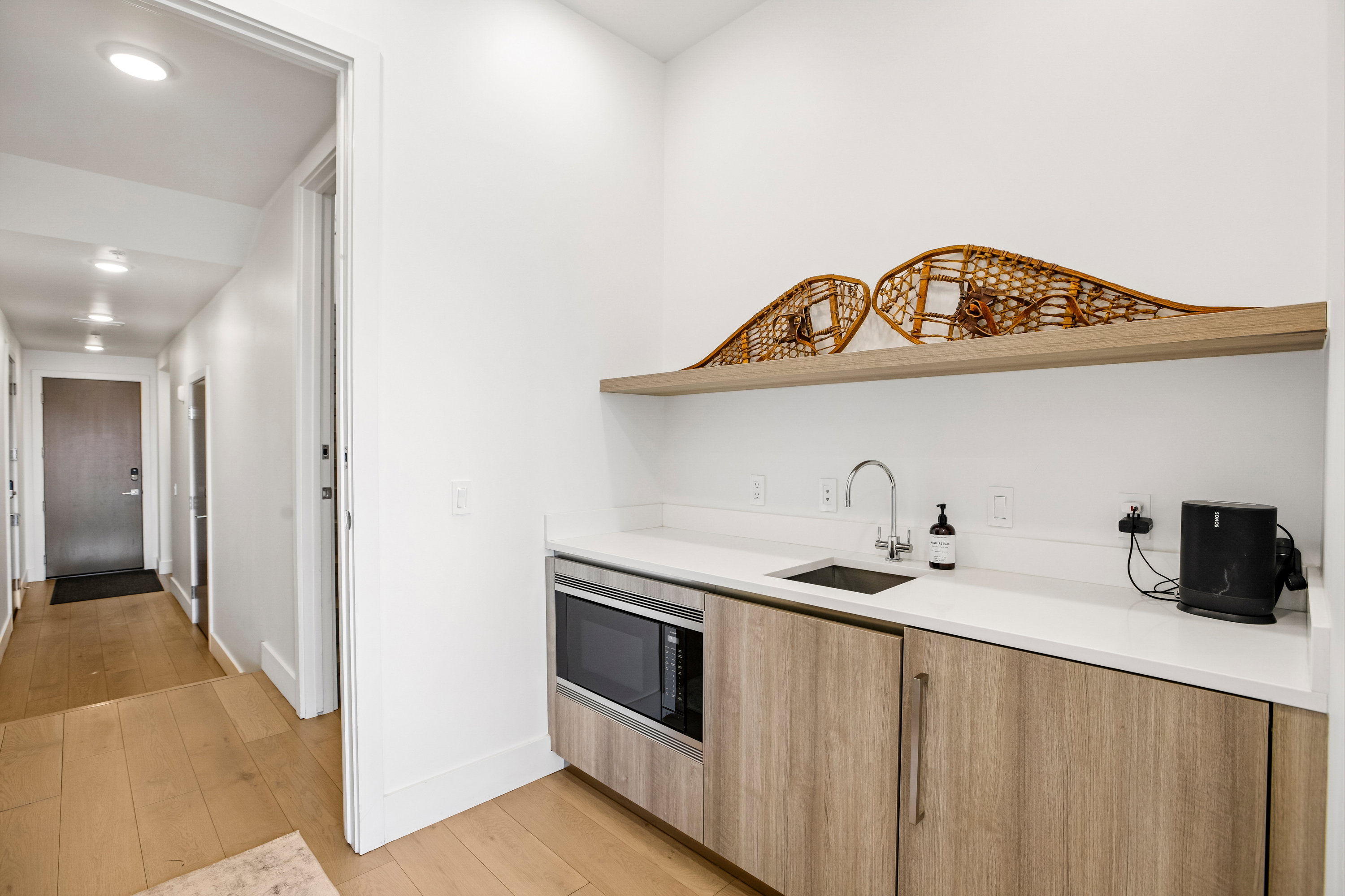 Hallway featuring wood-finish flooring and recessed lighting