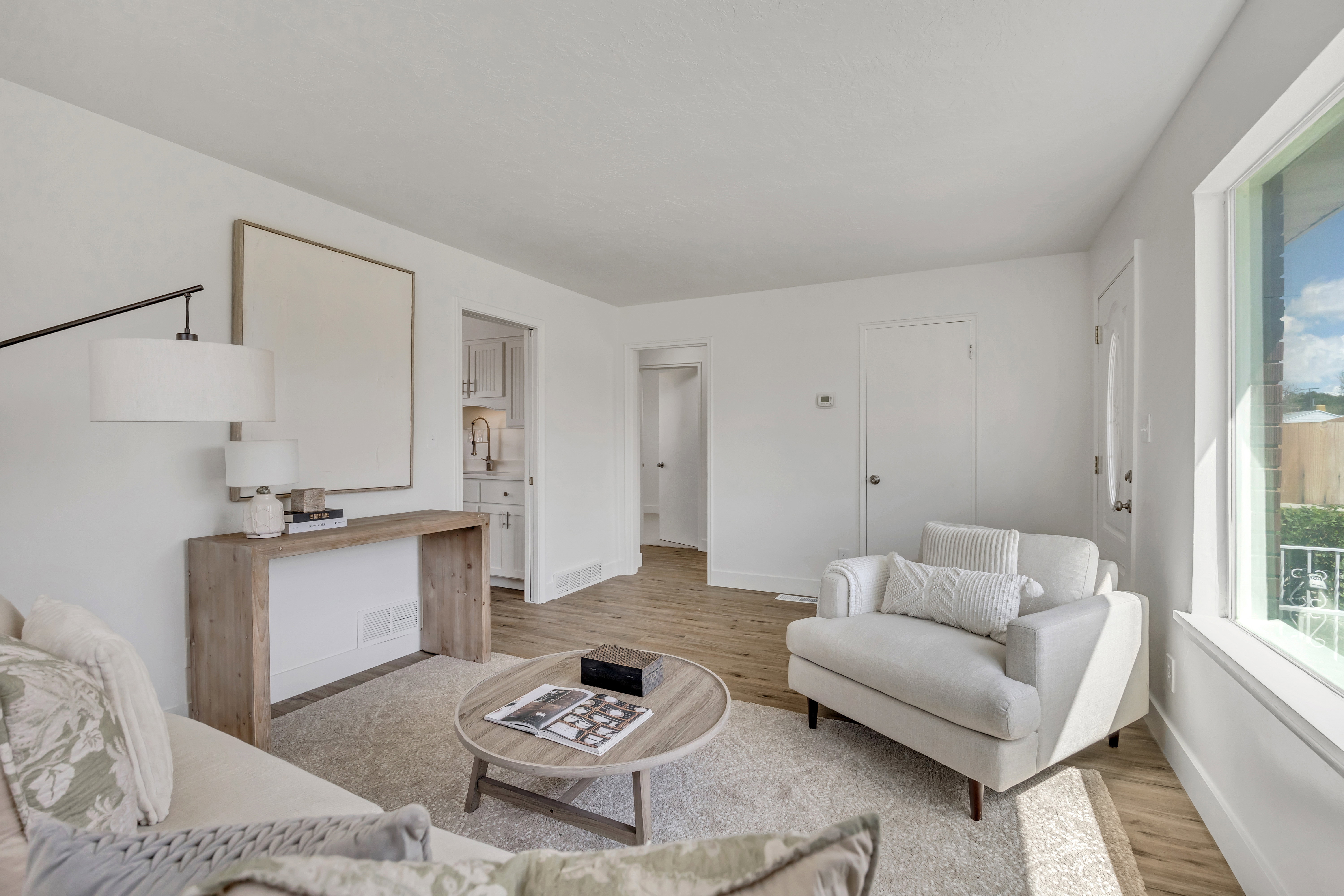 Bright interior featuring wood-finish flooring and white walls